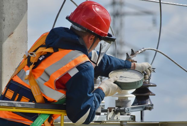 Electrician working safely on overhead lines