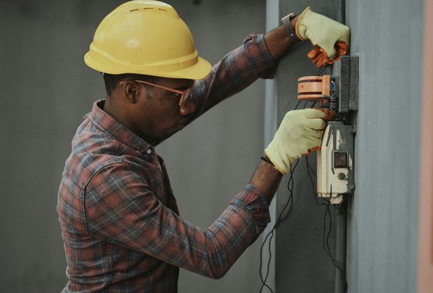 Electrician repairing a wall switch