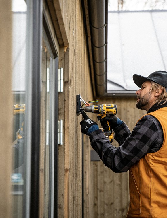 Electrician installing exterior lighting