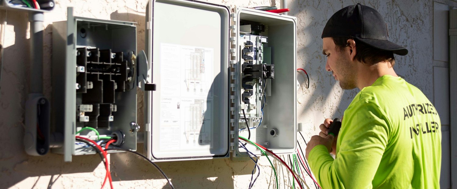 Voltworks electrician wiring an inverter and distribution board